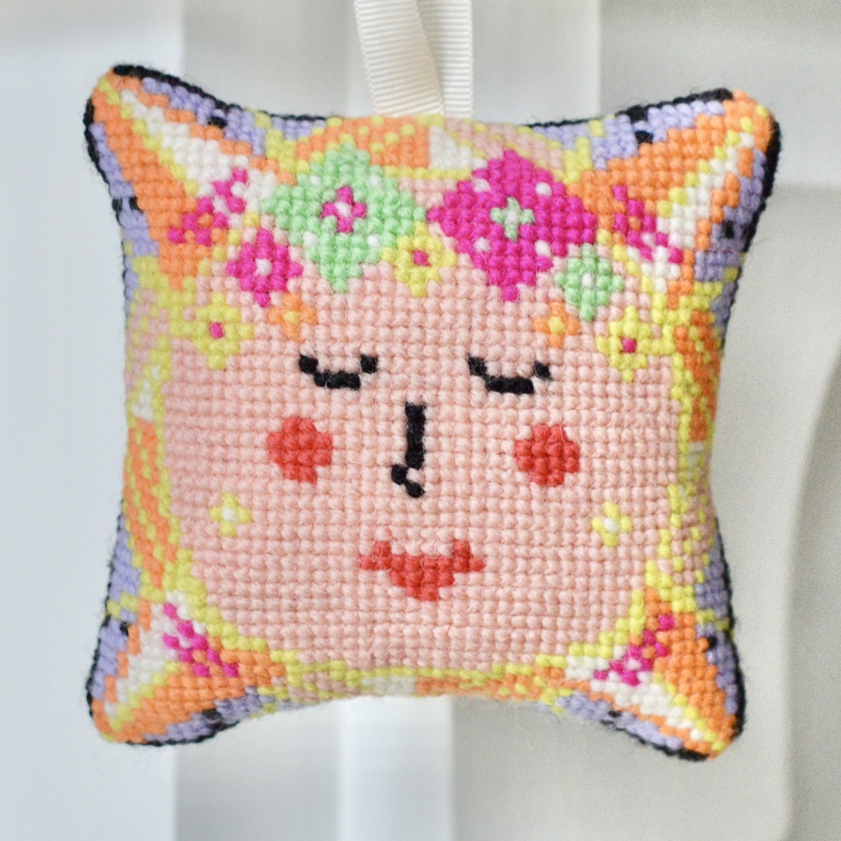 A sun face tapestry kit design depicting the radiant sun with intricate cross stitch details and warm hues, evoking a sense of energy and brightness, perfect for adding a vibrant touch to any space.