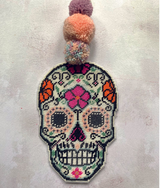 day of the dead needlepoint decoration stitched in vibrant colours of wool in pink and orange