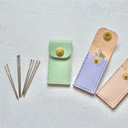 tapestry needles in sizes 20 and 22 with a handmade leather case