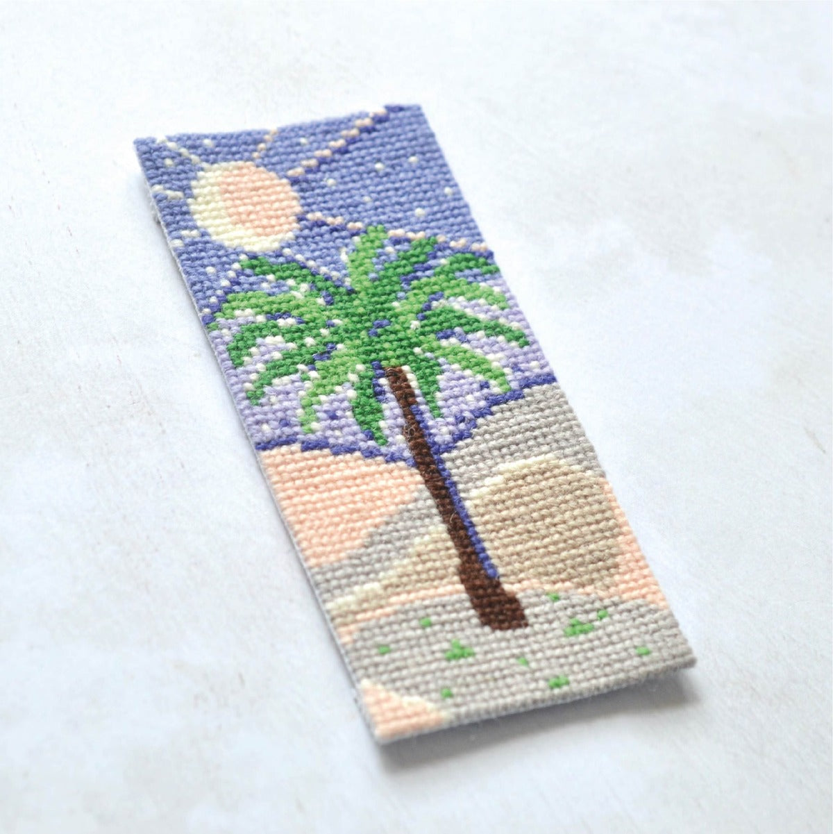 small cross stitch tapestry project featuring a palm tree. Cross stitch design for teenagers and adults