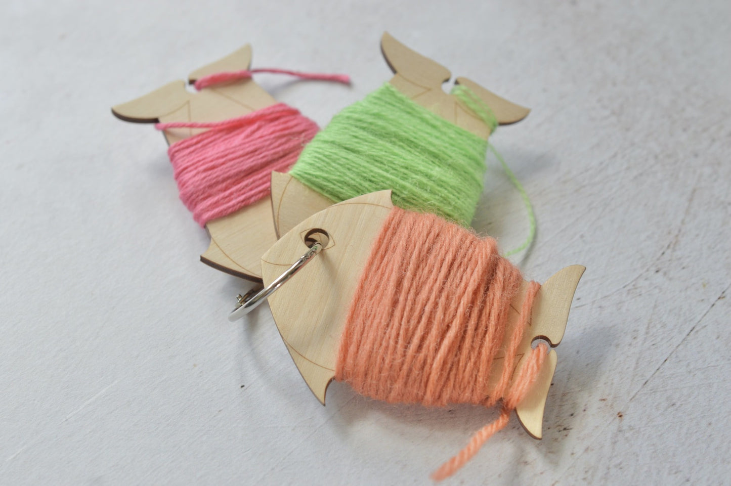 set of yarn bobbins held together with a ring.