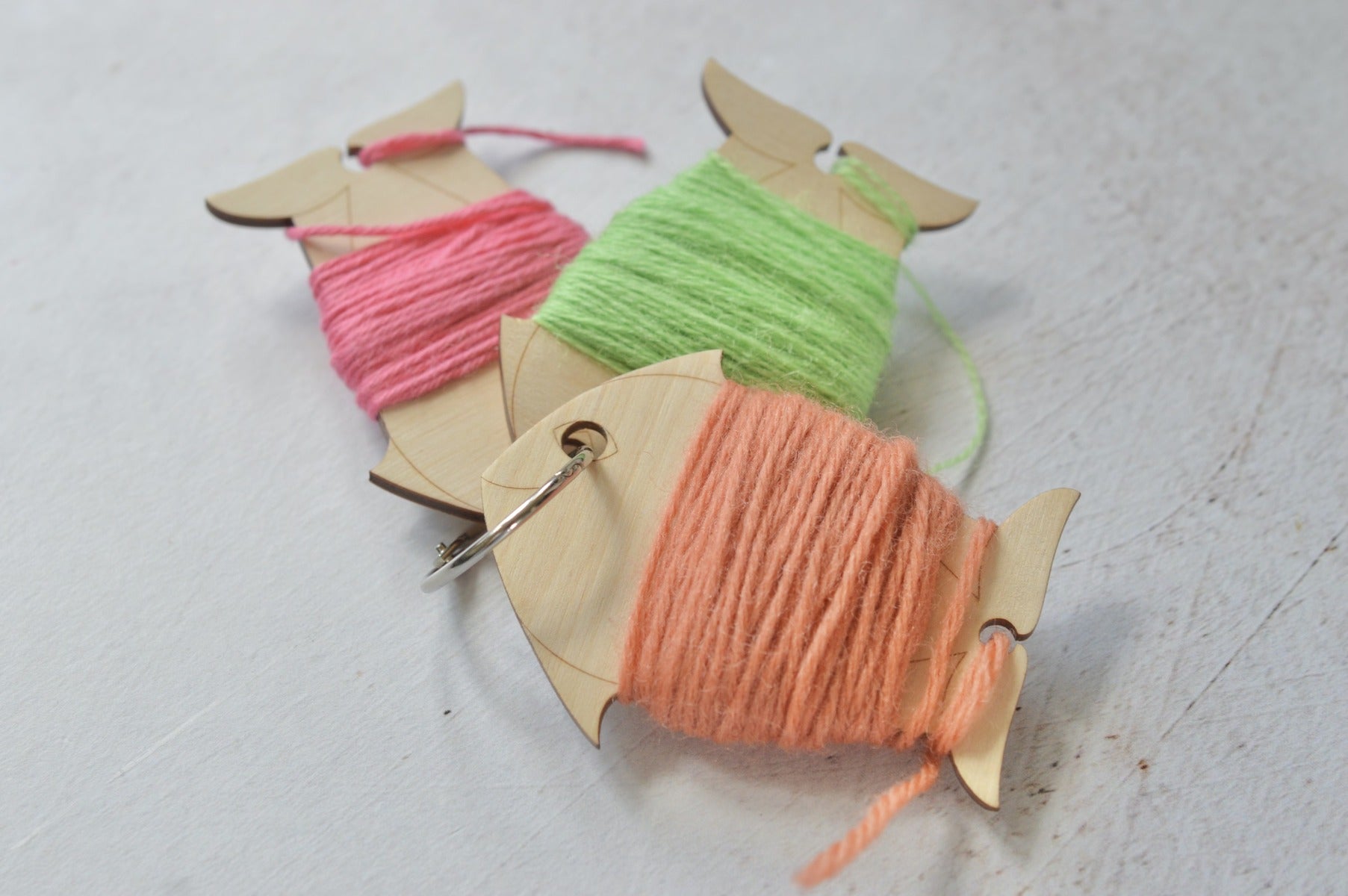 set of yarn bobbins held together with a ring.