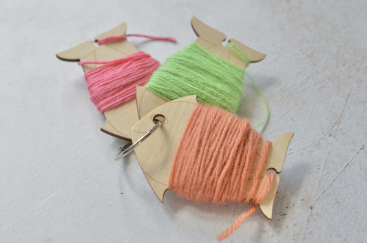 set of yarn bobbins held together with a ring.