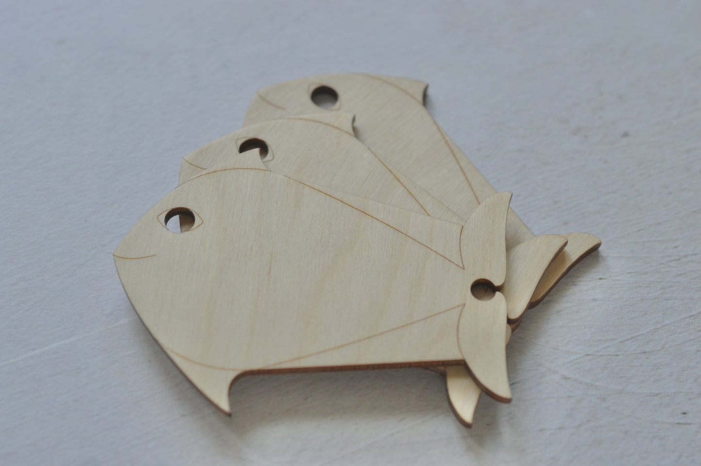 large yarn bobbins in the shape of a fish. can hold large amounts of wool or thread