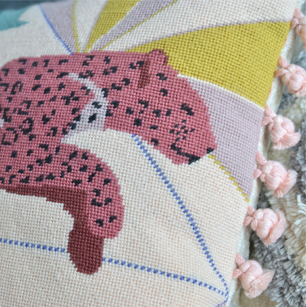 Close-up detail of a modern tapestry kit, showcasing intricate stitching in contemporary patterns and vibrant colors, providing a captivating glimpse into the artistry and craftsmanship of the project.