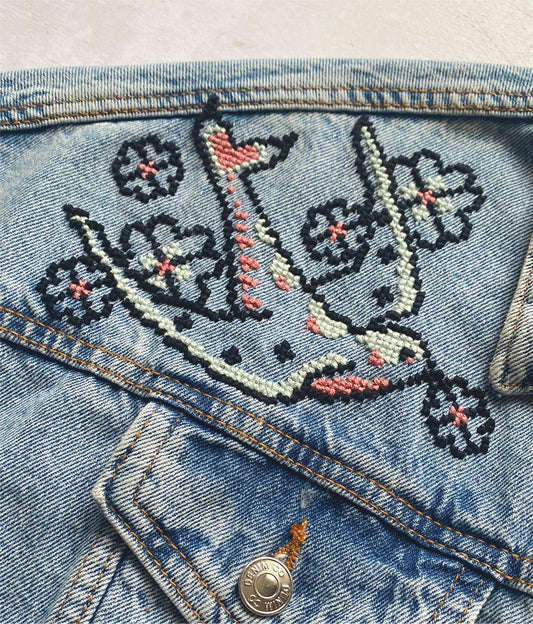cross stitch design available to download. Stitched using stranded cotton and cross stitched onto denim