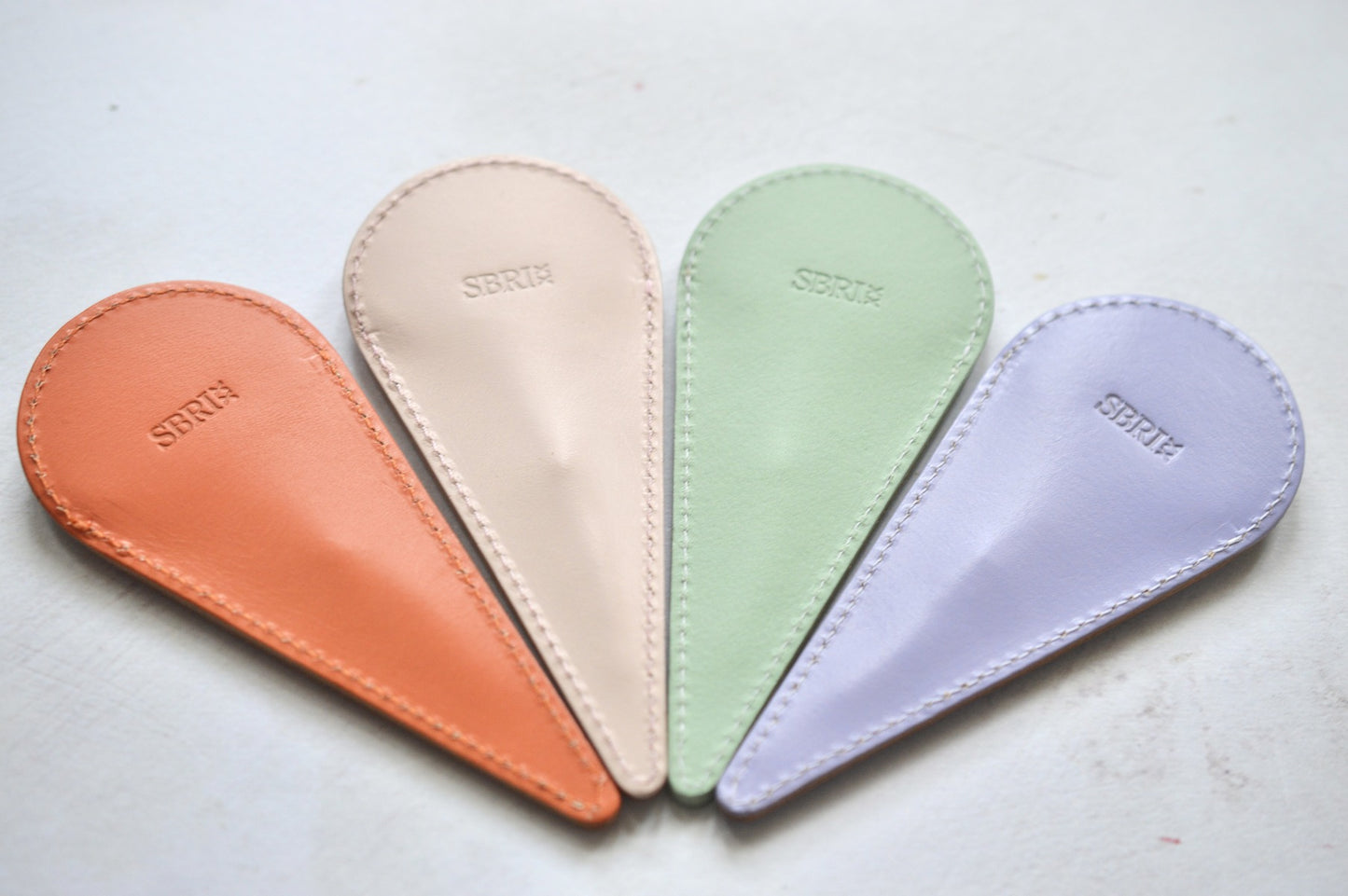colourful leather cases to hold sharp scissors 