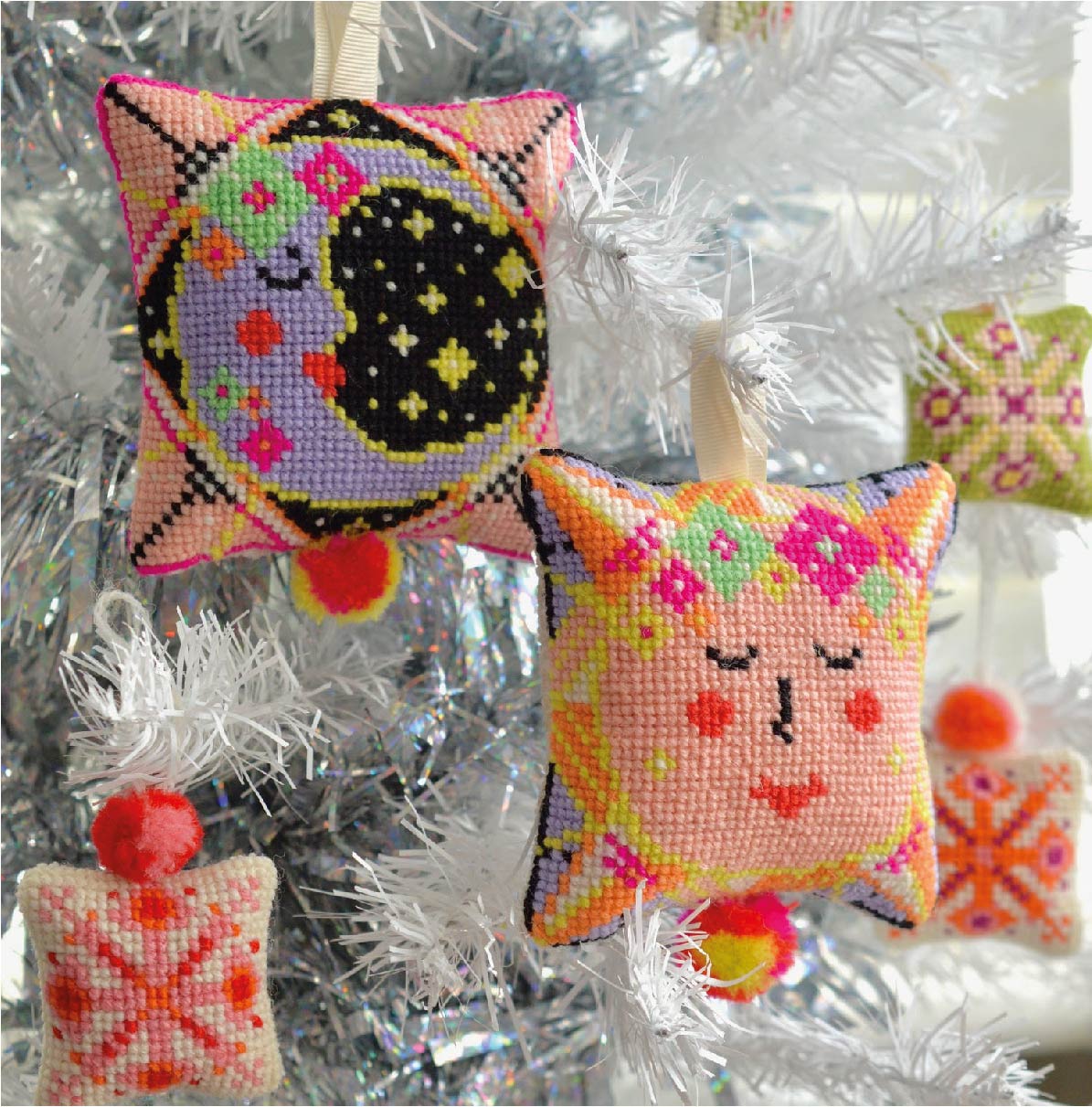 Sun and moon tapestry kit decorations adorning a Christmas tree, featuring the sun and moon designs adding a celestial touch to the holiday season.