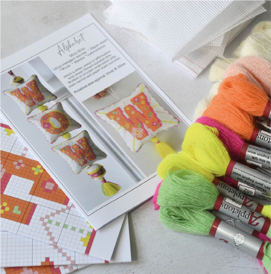 A tapestry kit suitable for beginners, containing brightly colour crewel wool, plain canvas and instructions.