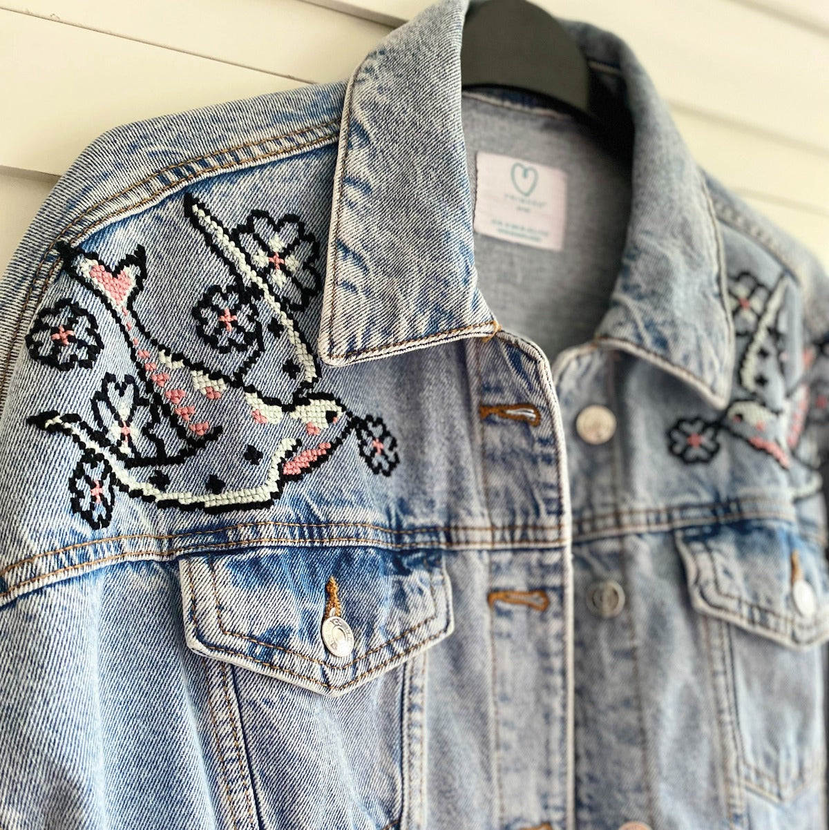 stranded cotton stitched using waste canvas onto a denim jacket