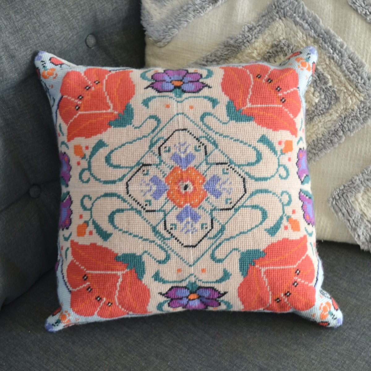 tapestry cushion stitched with vibrant colours of tapestry wool