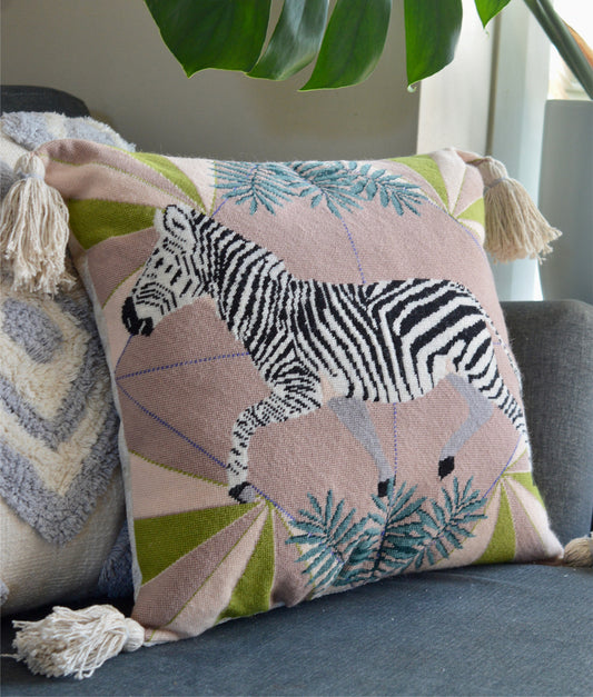 A zebra needlepoint kit made into a beautiful tapestry cushion. Showcasing a striking black and white zebra design, meticulously crafted with intricate stitching detail, offering a sophisticated and stylish accent for home decor enthusiasts.